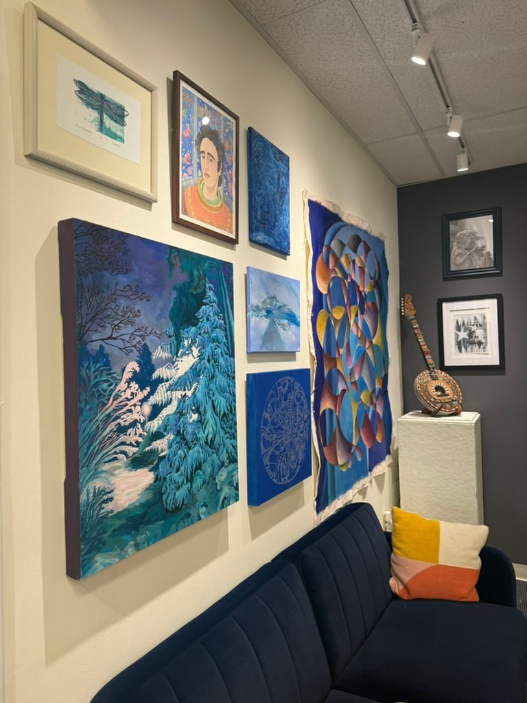 A salon-style gallery wall of cool-toned paintings — a curated artist showcase