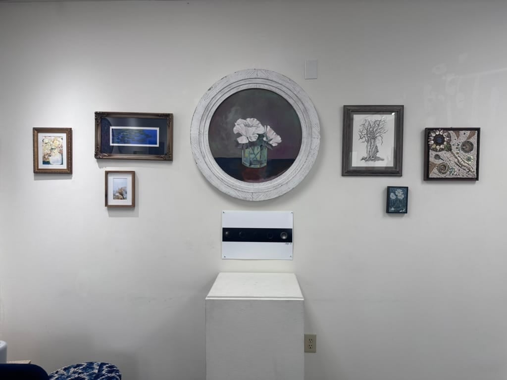 A salon-style gallery wall arrangement with multiple framed pieces hung for comparison